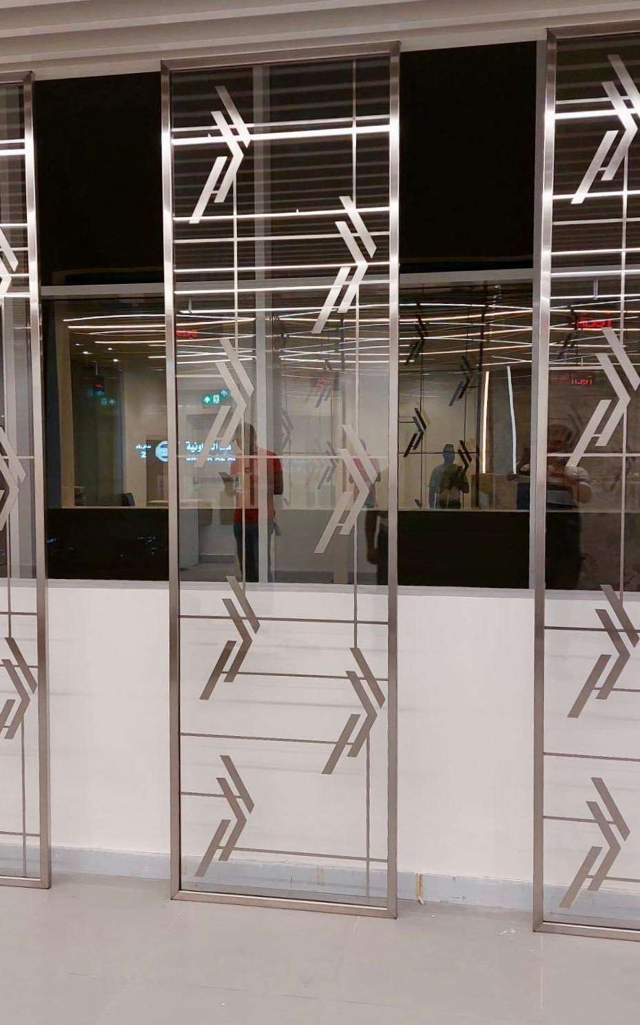 Stainless steel and glass door with decorative pattern